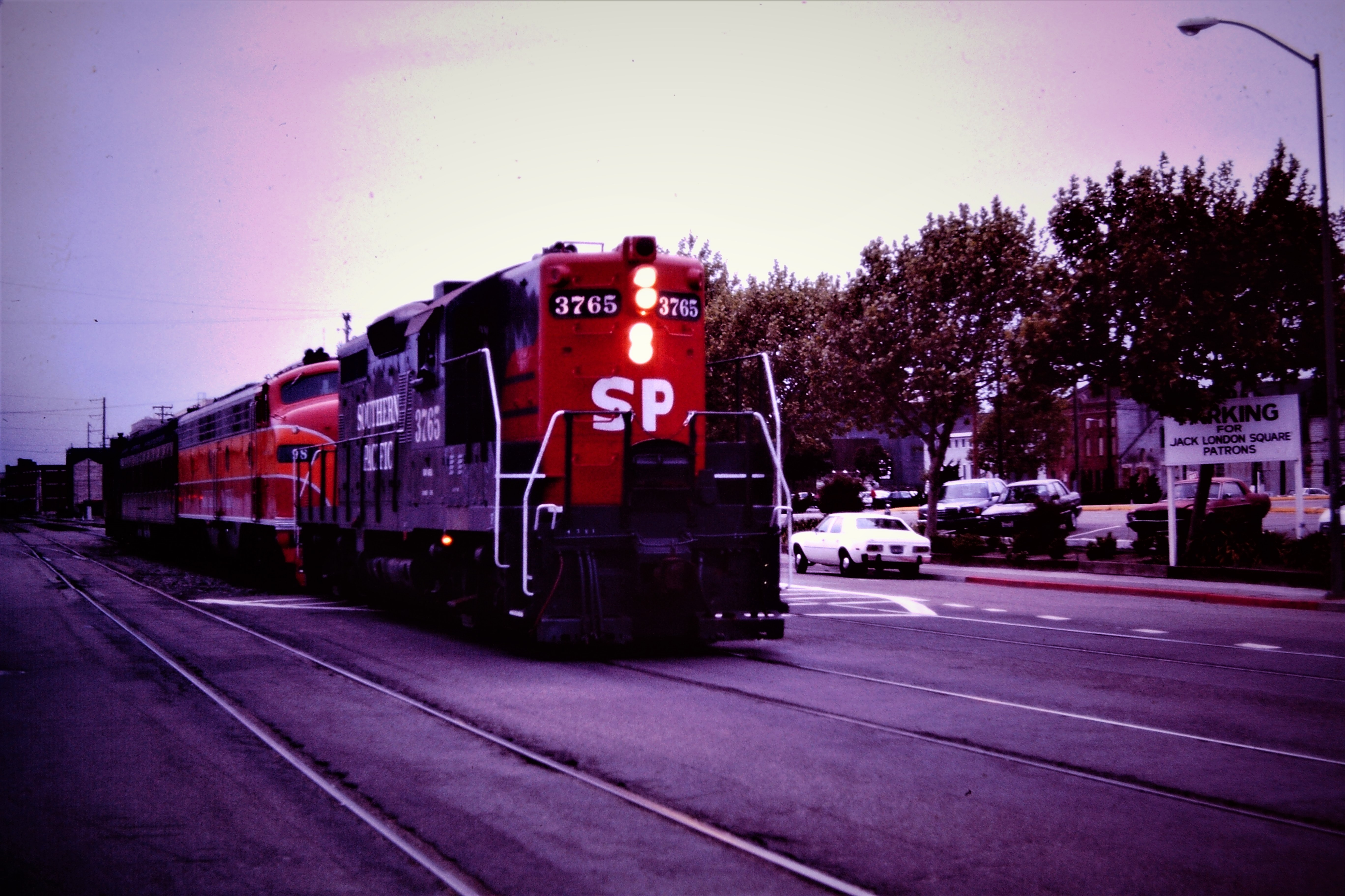 MAY 1985 in Oakland, Ca. I suspect a "museum" move of some sort. SP 3765 lights ablaze at Jack London Square. 